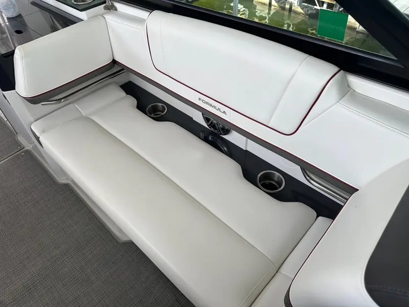 Slide: The Image of 2016 Formula 330 Crossover Bowrider interior with white seating and cup holders. - 16
