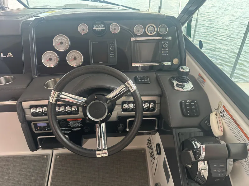 Slide: The Image of 2016 Formula 330 Crossover Bowrider dashboard with steering wheel and control panel. - 2
