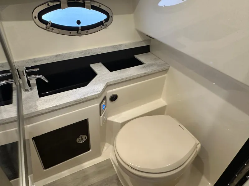 Slide: The Image of 2016 Formula 330 Crossover Bowrider bathroom with modern fixtures and porthole window. - 22