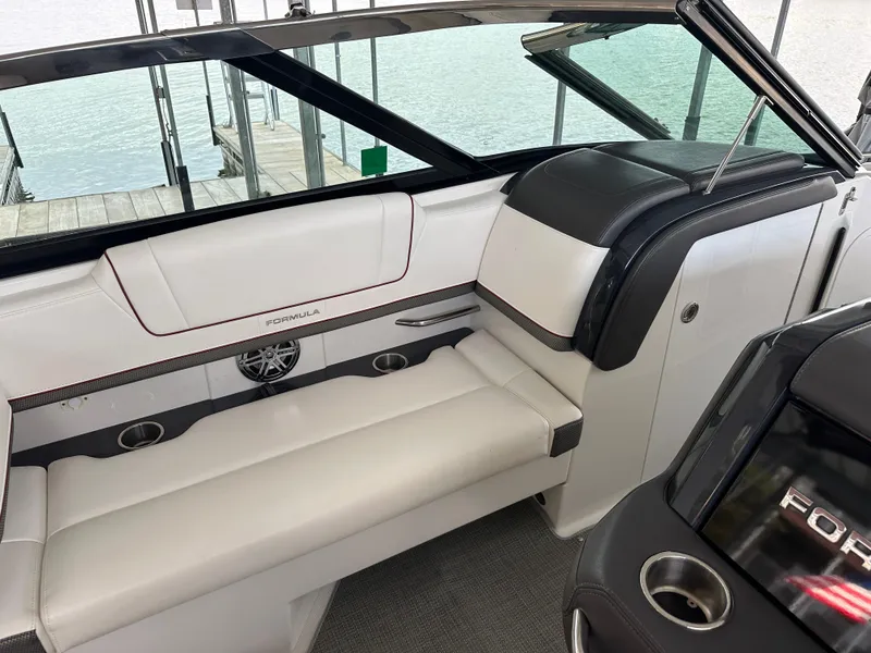 Slide: The Image of 2016 Formula 330 Crossover Bowrider interior with white seating and sleek design. - 25