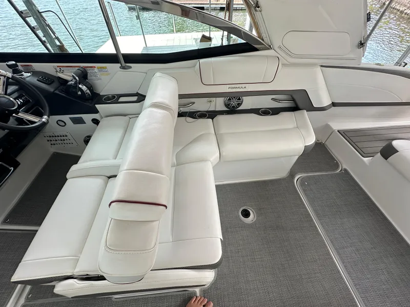 Slide: The Image of 2016 Formula 330 Crossover Bowrider interior with white seating and helm. - 28