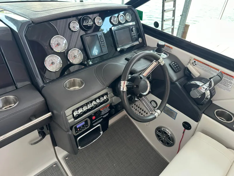 Slide: The Image of 2016 Formula 330 Crossover Bowrider dashboard with steering wheel and control panel. - 3