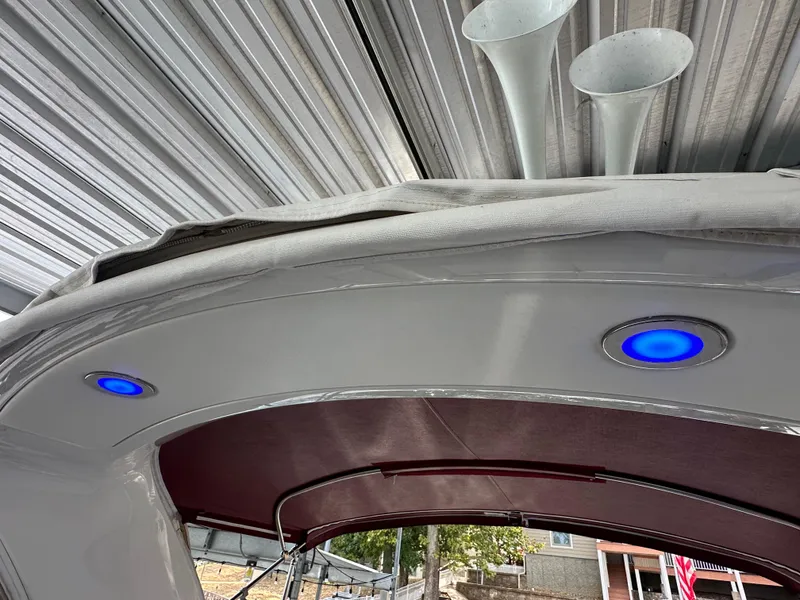 Slide: The Image of 2016 Formula 330 Crossover Bowrider with blue LED lights under a metal canopy. - 34