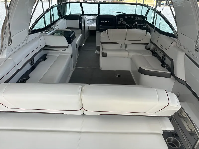 Slide: The Image of 2016 Formula 330 Crossover Bowrider interior with white seating and modern dashboard. - 37