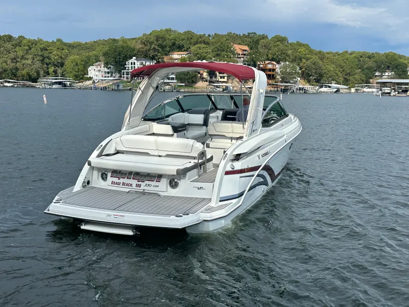 Slide: The Image of 2016 Formula 330 Crossover Bowrider on a scenic lake with lush greenery. - 44