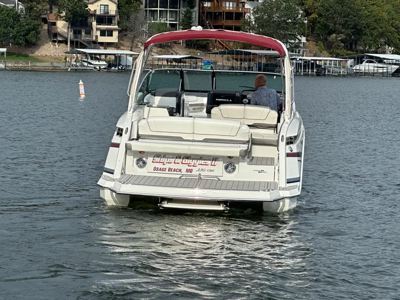 Slide: The Image of 2016 Formula 330 Crossover Bowrider on a lake, rear view with red canopy. - 46