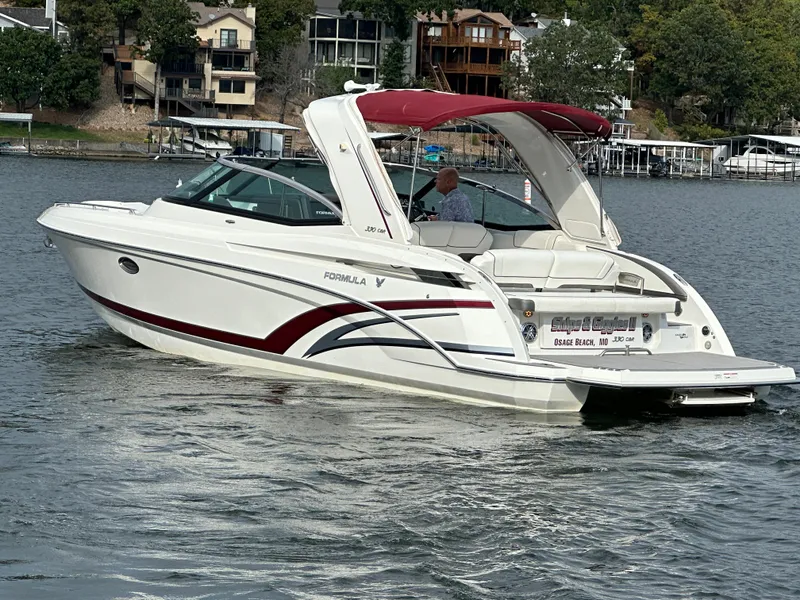 Slide: The Image of 2016 Formula 330 Crossover Bowrider on a lake with red canopy. - 49