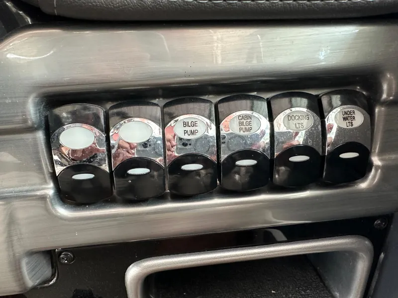 Slide: The Image of Control panel switches on a 2016 Formula 330 Crossover Bowrider boat. - 8