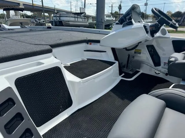 Slide: The Image of 2025 iKon VLX21 boat interior with gray seating and carpeted deck. - 12