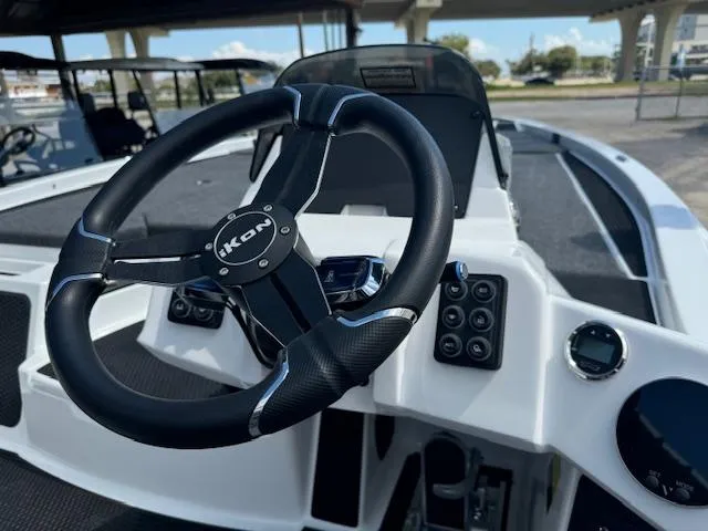 Slide: The Image of 2025 iKon VLX21 boat interior with dual gray seats and modern dashboard. - 13