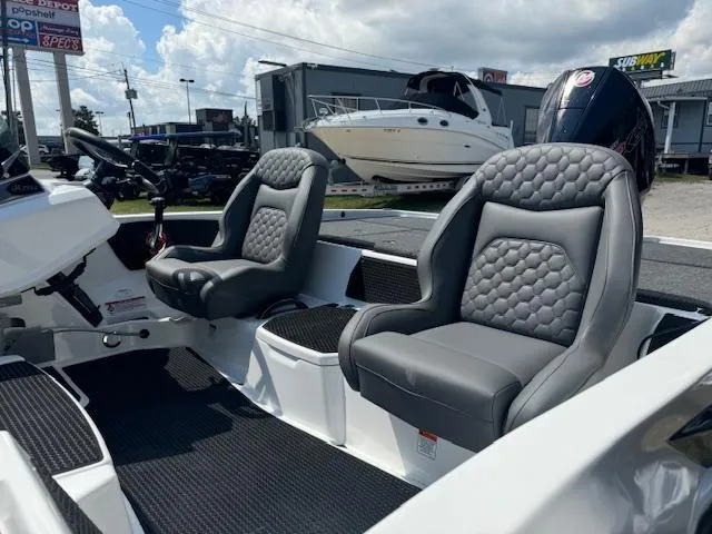 Slide: The Image of Two gray seats on a 2025 iKon VLX21 boat with carpeted deck. - 15