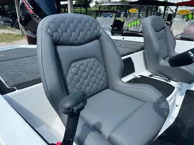 Slide: The Image of 2025 iKon VLX21 boat interior with open storage compartments and two gray seats. - 16