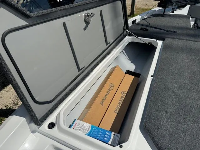 Slide: The Image of 2025 iKon VLX21 boat with cover on trailer, parked outside a building. - 23