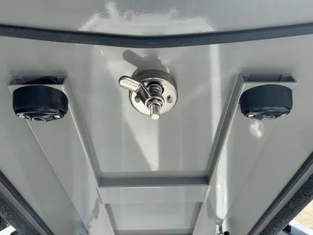 Slide: The Image of 2025 iKon VLX21 boat covered on trailer, parked outdoors with other boats. - 24