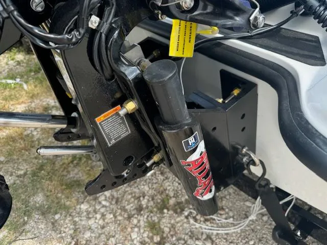 Slide: The Image of 2025 iKon VLX21 boat on trailer, parked outdoors with trees in background. - 6