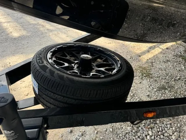 Slide: The Image of 2025 iKon VLX21 boat on trailer, parked outdoors, featuring sleek design and modern equipment. - 7