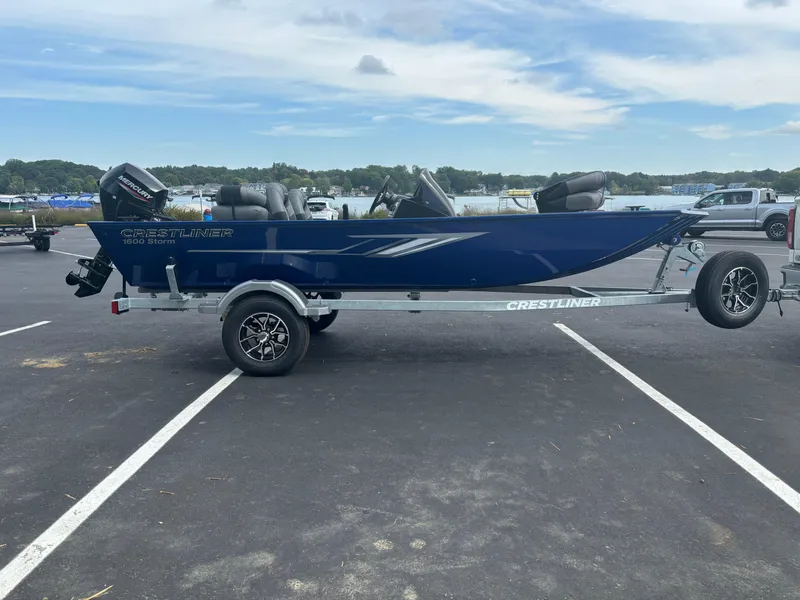Slide: The Image of 2025 Crestliner 1600 Storm boat on trailer in parking lot. - 0