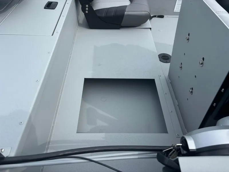 Slide: The Image of 2025 Crestliner 1600 Storm boat interior with storage compartment and seating. - 10
