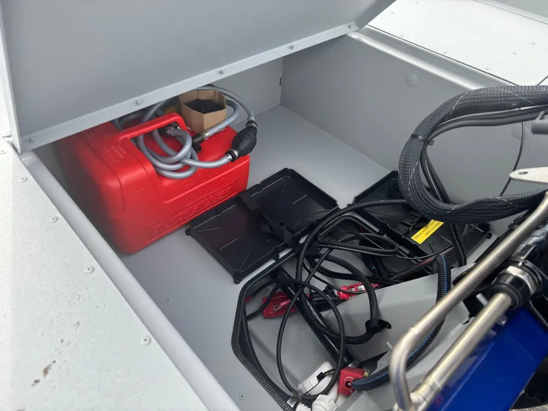 Slide: The Image of Storage compartment of 2025 Crestliner 1600 Storm boat with fuel tank and cables. - 11
