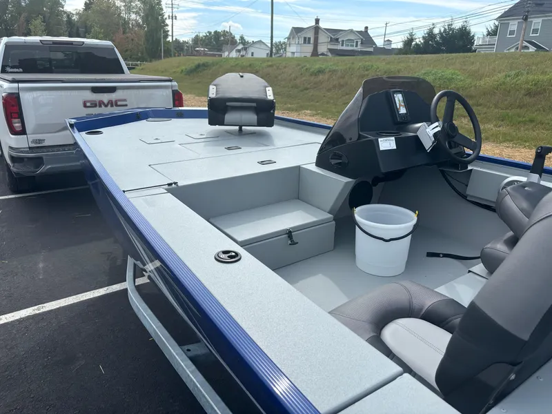 Slide: The Image of 2025 Crestliner 1600 Storm boat hitched to a GMC truck in a parking lot. - 12