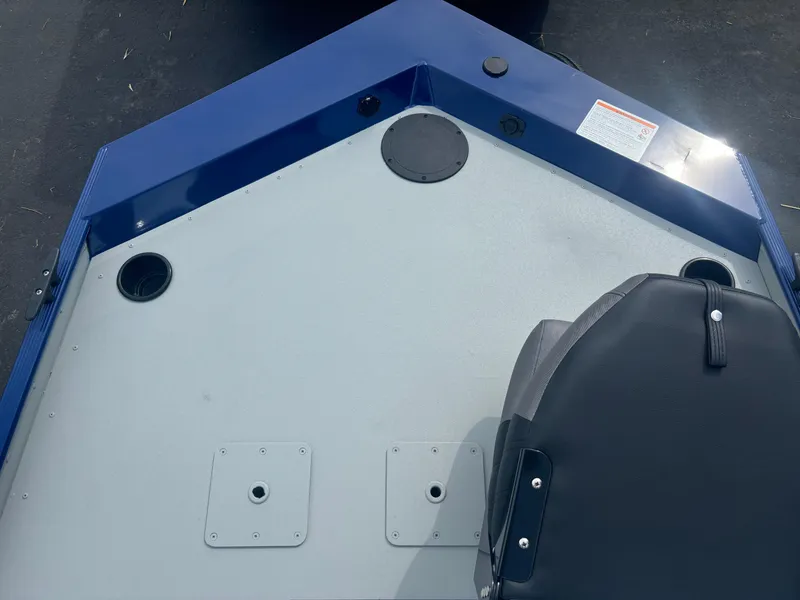 Slide: The Image of 2025 Crestliner 1600 Storm boat deck with seating and storage compartments. - 4