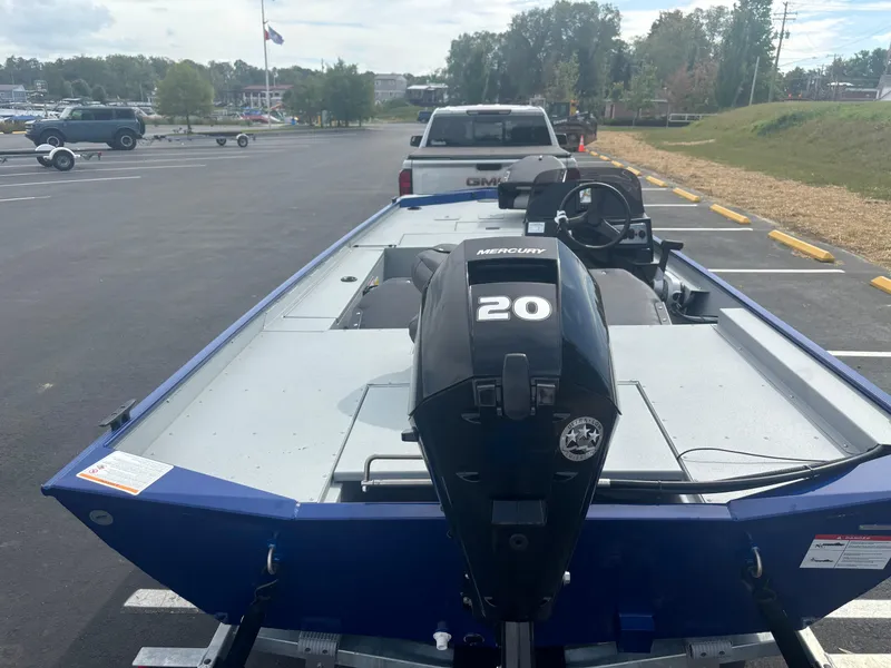 Slide: The Image of 2025 Crestliner 1600 Storm boat with Mercury 20 engine in parking lot. - 5