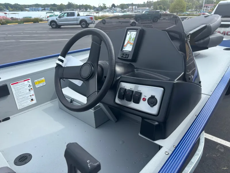 Slide: The Image of 2025 Crestliner 1600 Storm boat dashboard with steering wheel and control panel. - 9