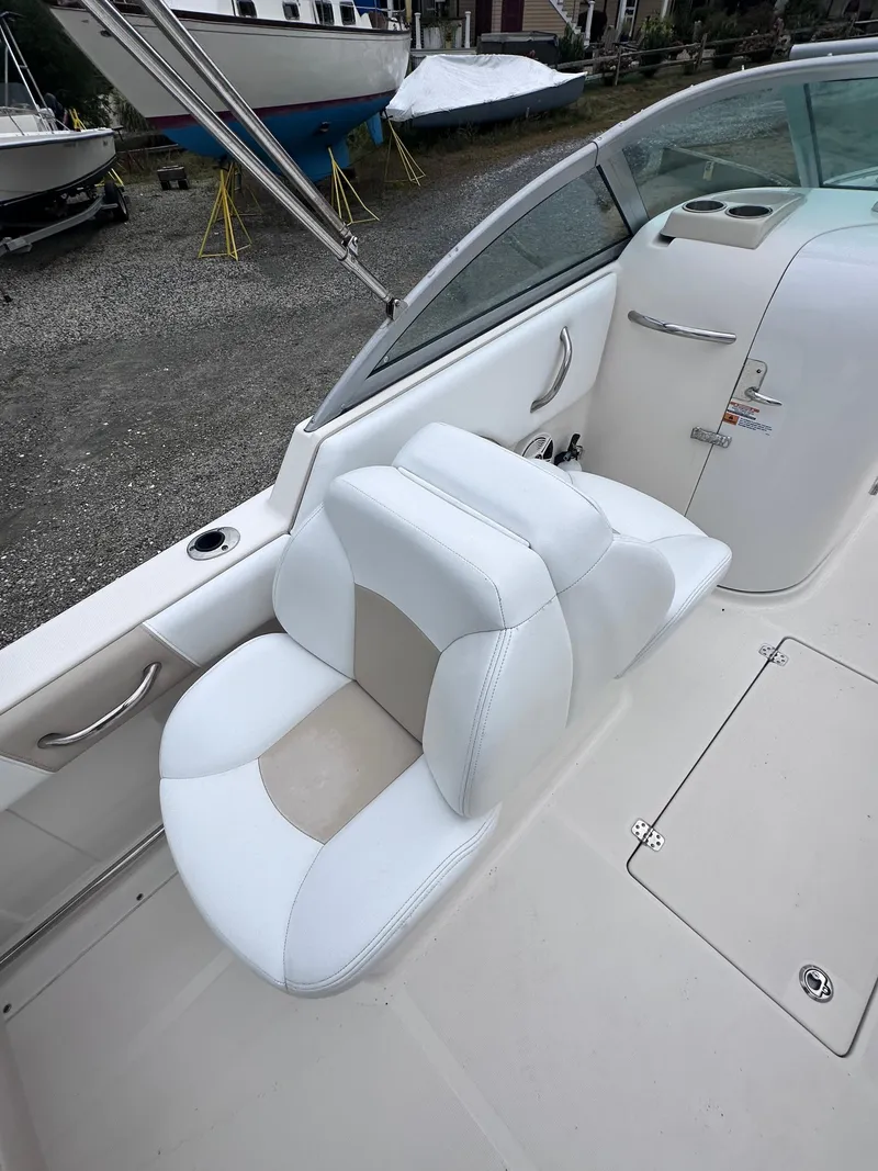 Slide: The Image of 2018 Robalo R227 Dual Console boat interior with white seating and sleek design. - 2