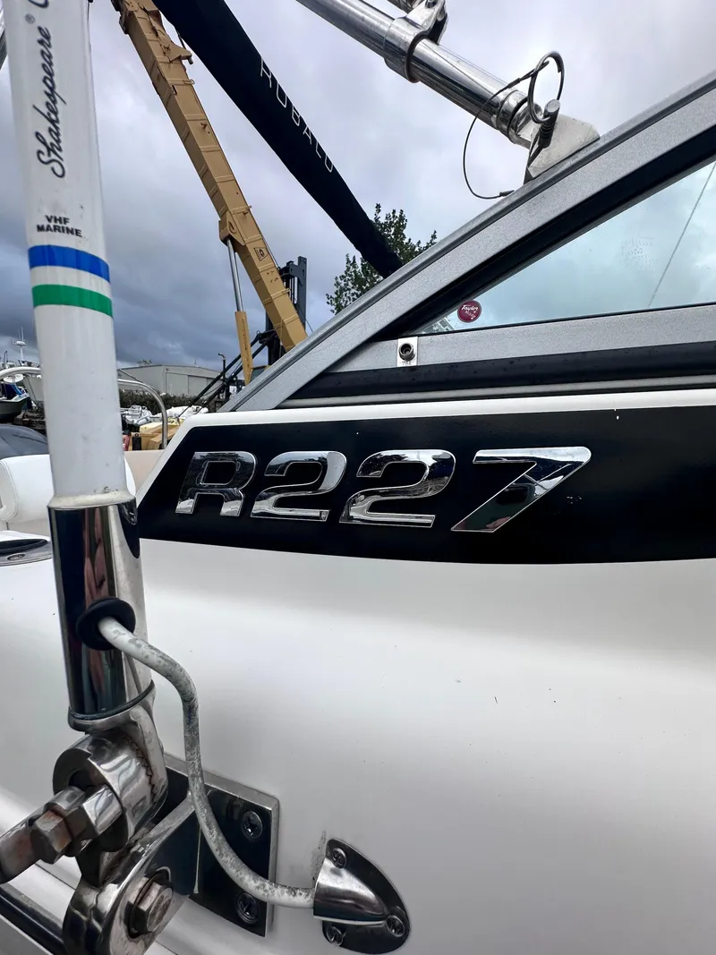 Slide: The Image of 2018 Robalo R227 Dual Console boat, close-up of model emblem and railing. - 3