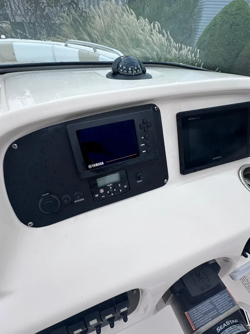 Slide: The Image of 2018 Robalo R227 Dual Console dashboard with Yamaha electronics and compass. - 4