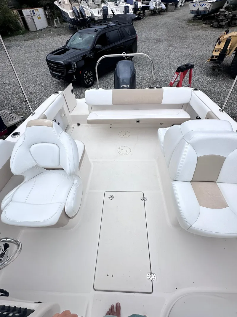 Slide: The Image of 2018 Robalo R227 Dual Console boat with white seating and spacious deck. - 5