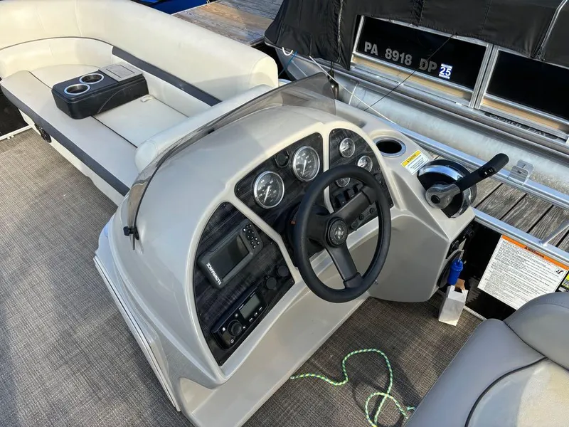 Slide: The Image of 2020 Sweetwater SW 2186 SB boat interior with steering console and seating area. - 12