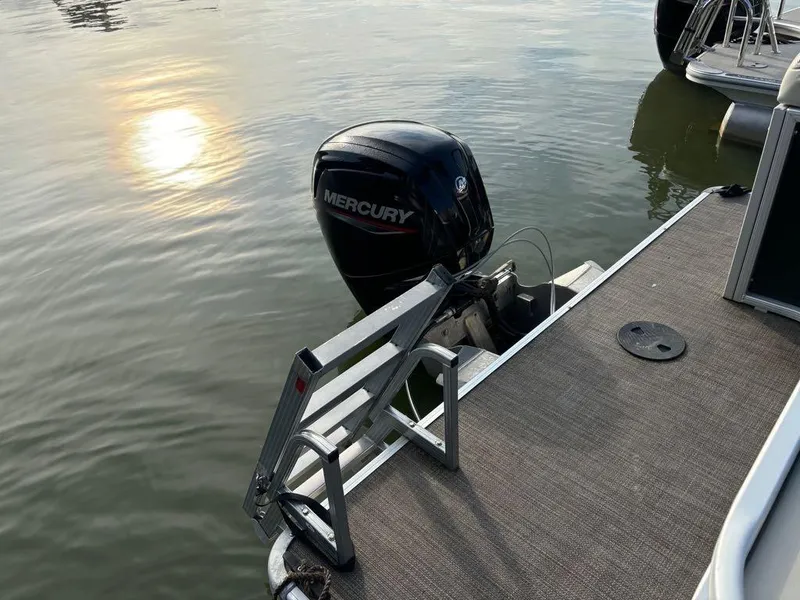 Slide: The Image of 2020 Sweetwater SW 2186 SB pontoon boat with Mercury outboard motor on calm water. - 13