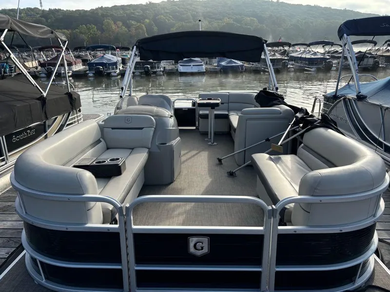 Slide: The Image of 2020 Sweetwater SW 2186 SB pontoon boat docked at a marina. - 4