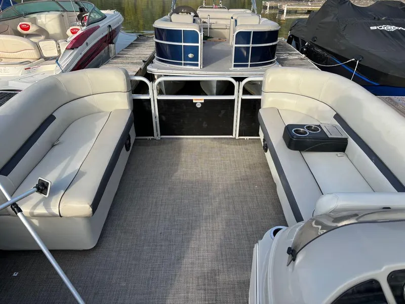 Slide: The Image of 2020 Sweetwater SW 2186 SB pontoon boat interior with beige seating and cup holders. - 6