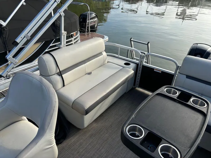 Slide: The Image of 2020 Sweetwater SW 2186 SB pontoon boat interior with seating and table on calm water. - 7