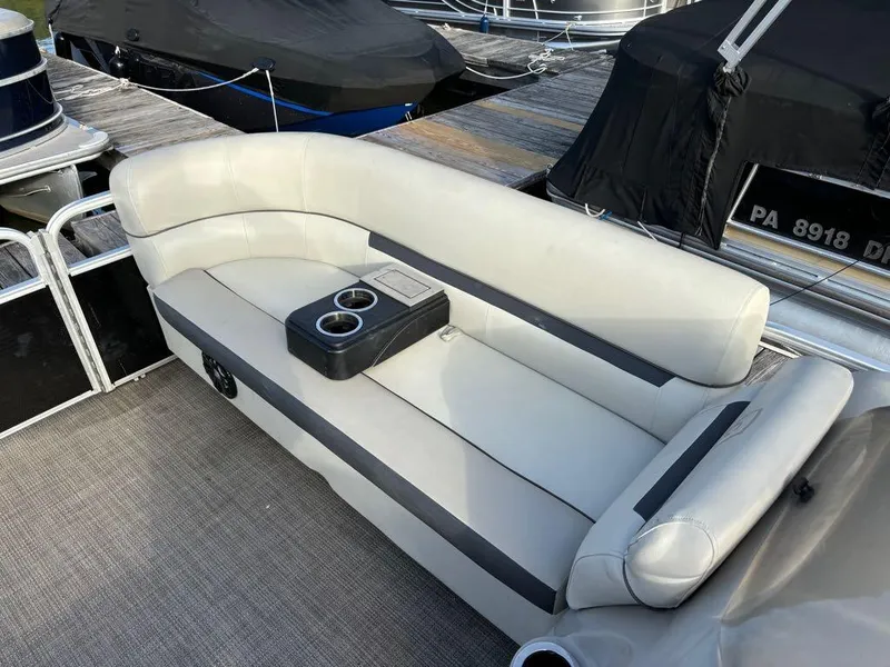 Slide: The Image of 2020 Sweetwater SW 2186 SB boat with white seating and cup holders on a dock. - 8