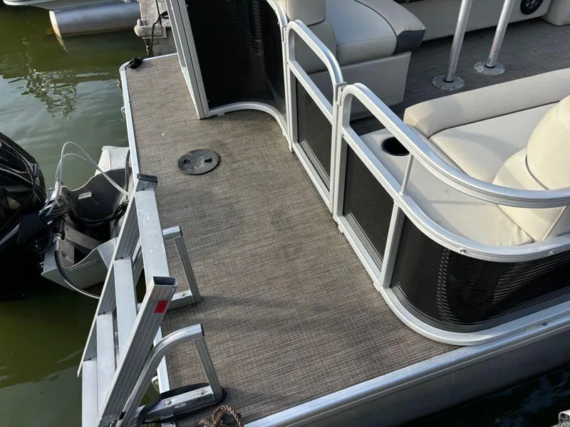 Slide: The Image of 2020 Sweetwater SW 2186 SB pontoon boat deck with seating and motor. - 9