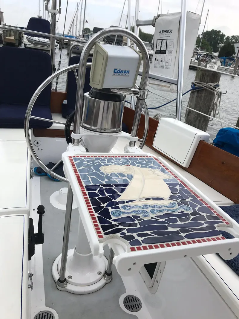 Slide: The Image of 1974 Tartan 34C sailboat cockpit with nautical-themed mosaic table. - 10