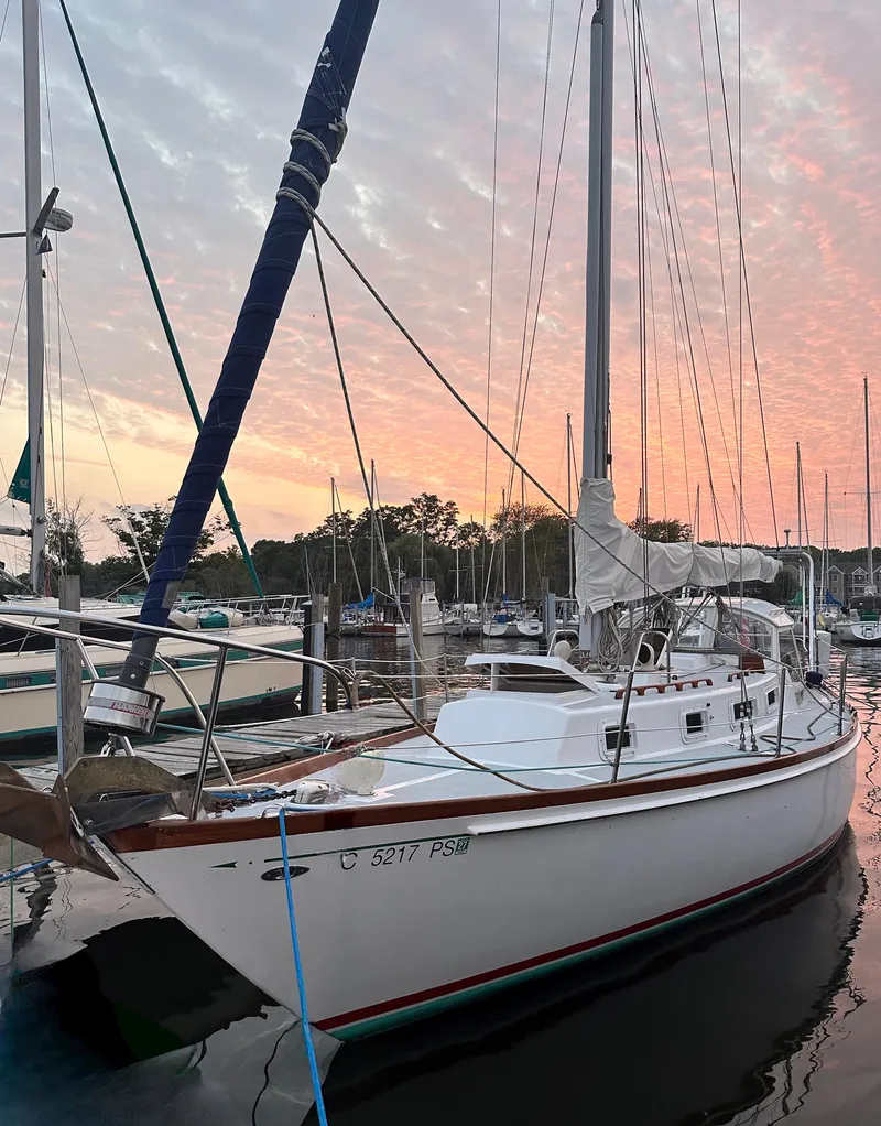 Slide: The Image of 1974 Tartan 34C sailboat docked at sunset, serene marina setting. - 3