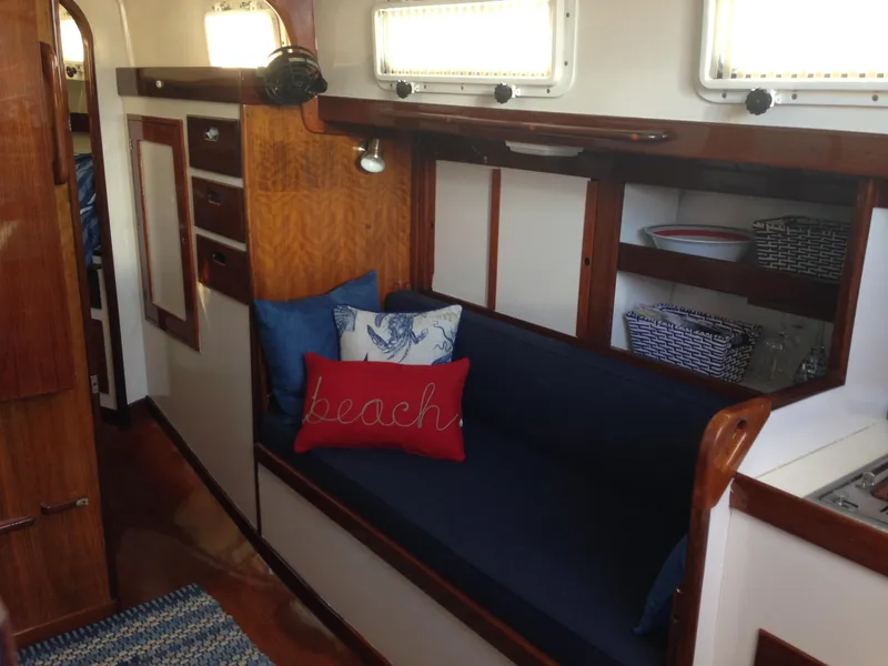 Slide: The Image of 1974 Tartan 34C sailboat interior with cozy seating and nautical decor. - 8