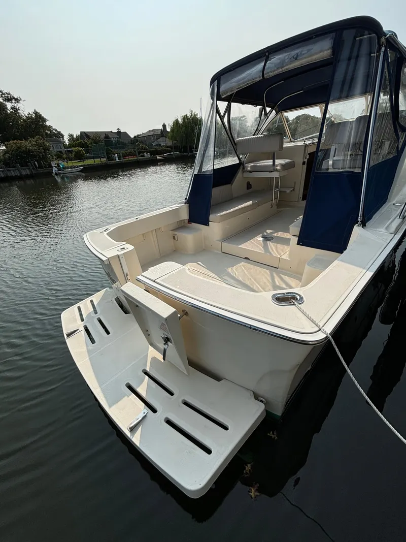 Slide: The Image of 2005 Mainship Pilot 30-II Sedan boat docked on calm water. - 12