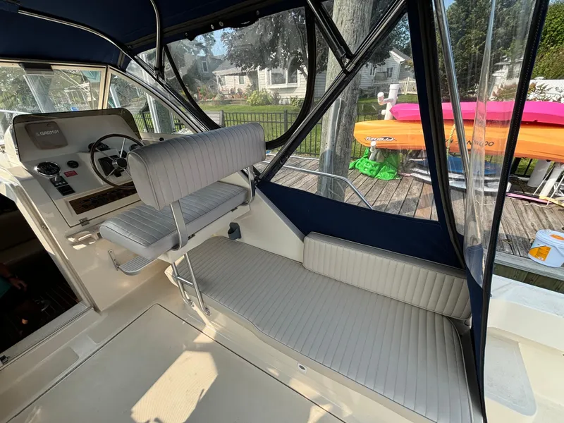 Slide: The Image of 2005 Mainship Pilot 30-II Sedan interior with helm and seating area. - 17