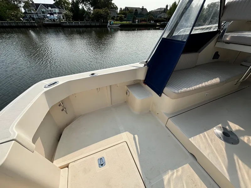 Slide: The Image of 2005 Mainship Pilot 30-II Sedan boat interior, featuring spacious seating and waterfront view. - 20