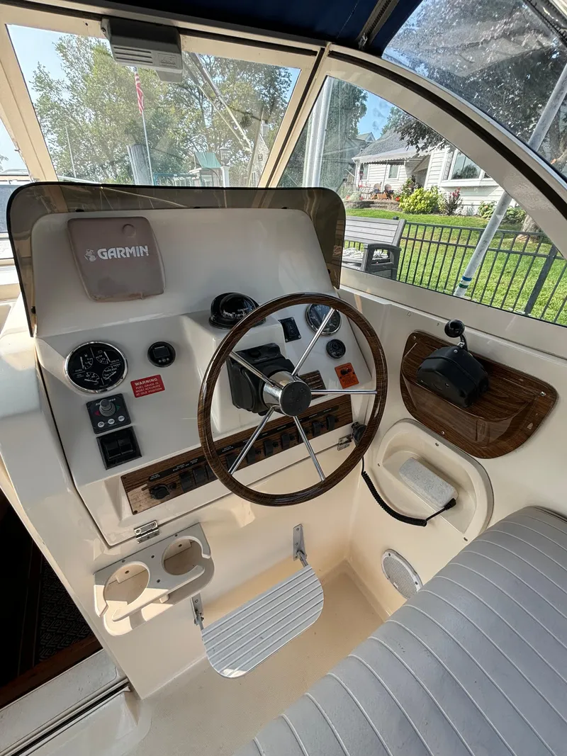Slide: The Image of 2005 Mainship Pilot 30-II Sedan helm with Garmin navigation and classic wood accents. - 22