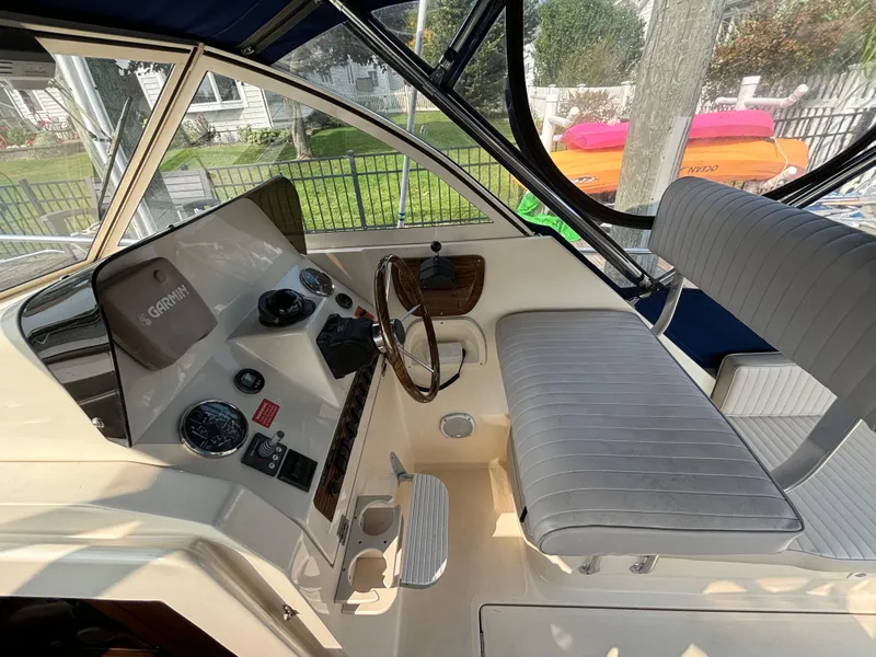Slide: The Image of 2005 Mainship Pilot 30-II Sedan helm with steering wheel and navigation equipment. - 23