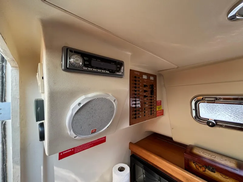 Slide: The Image of 2005 Mainship Pilot 30-II Sedan interior with stereo, speaker, and control panel. - 30