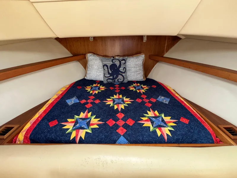 Slide: The Image of Cozy cabin interior of 2005 Mainship Pilot 30-II Sedan with colorful quilted bedding. - 32