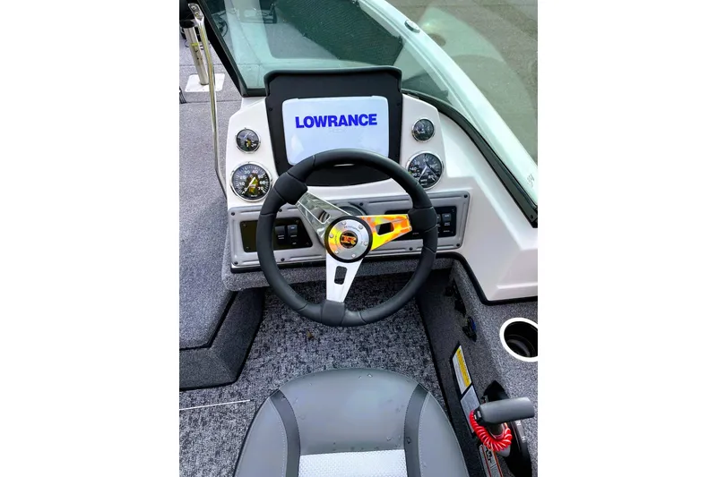 Slide: The Image of 2024 Ranger VS1882 WT boat dashboard with Lowrance display and steering wheel. - 2
