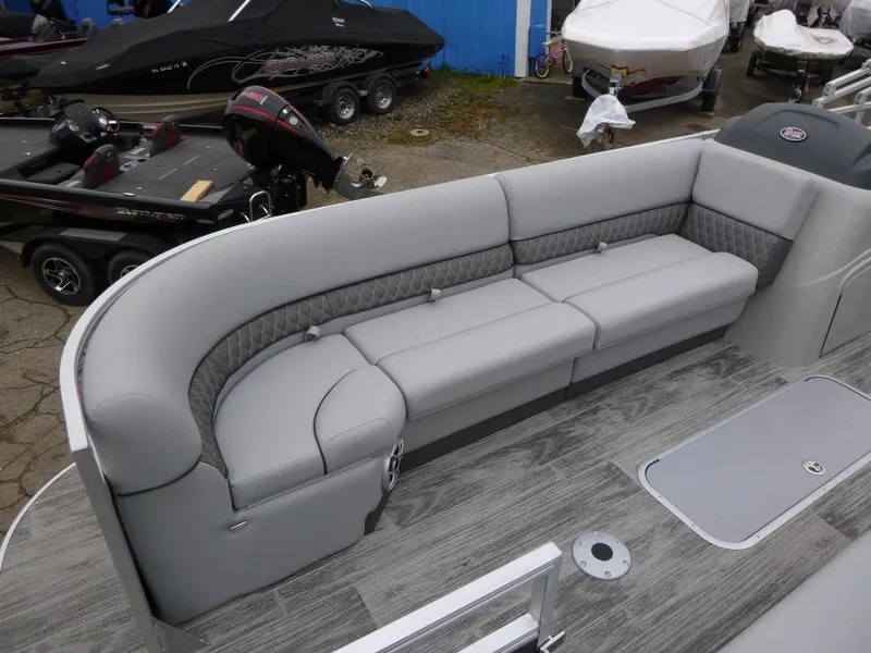 Slide: The Image of 2024 Ranger Reata 223C boat with gray seating and modern deck design. - 12